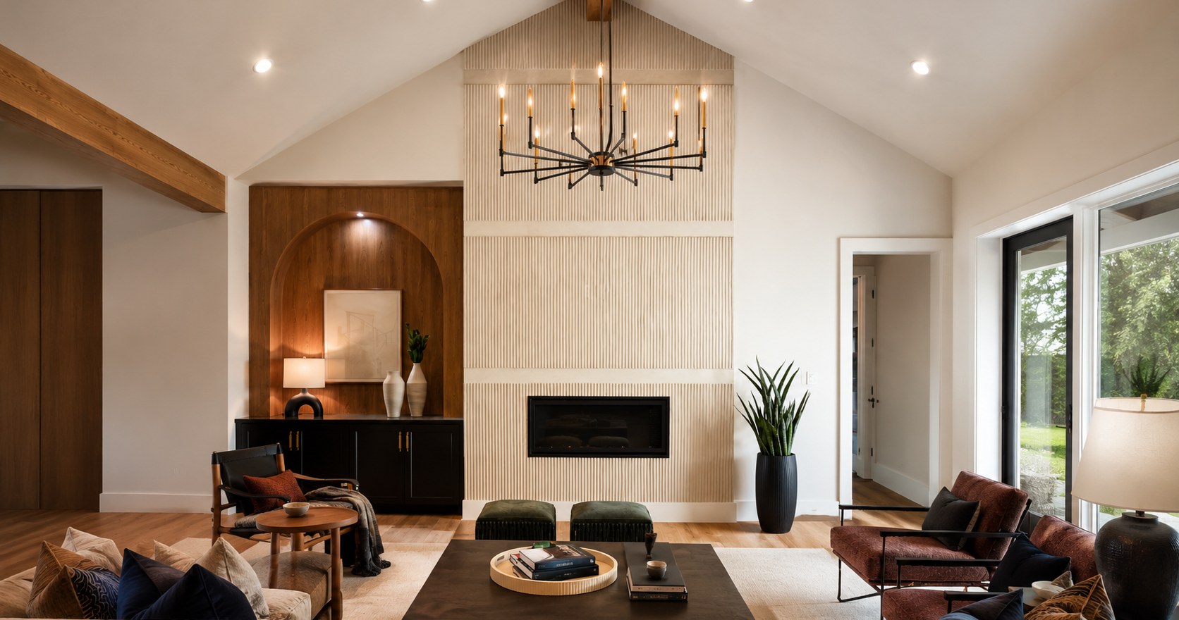 Living room with a cream fluted fireplace wall and a hanging chandelier.